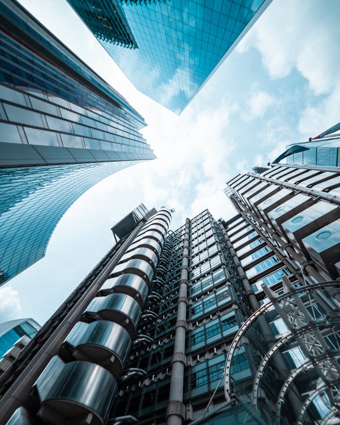 Low angle view of modern skyscrapers in London, capturing sleek architectural designs against the sky.